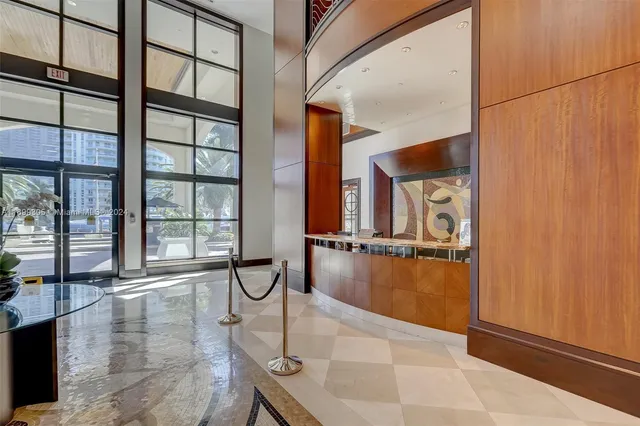 a balcony with chairs and with potted plants