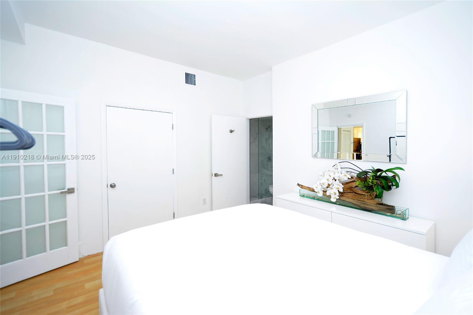 1342 Drexel Avenue, Unit 105 Miami Beach, FL 33139 - Photo 3 of 12 a spacious bedroom with a bed and a table in it