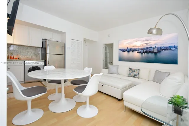 a living room with furniture and a dining table