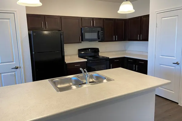 a kitchen with a refrigerator and a sink