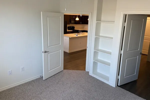 a view of walk in closet with empty racks