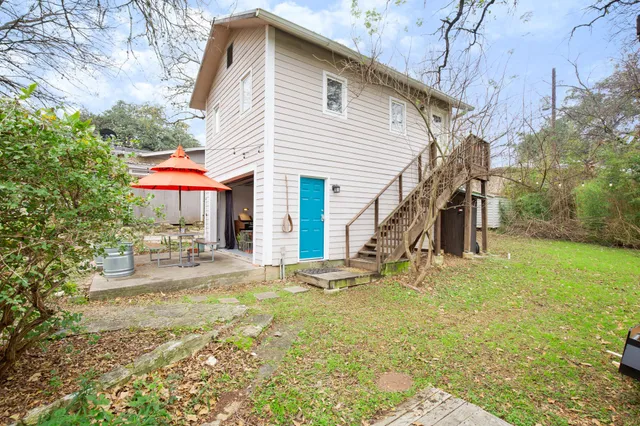 a view of a house with a yard and sitting area