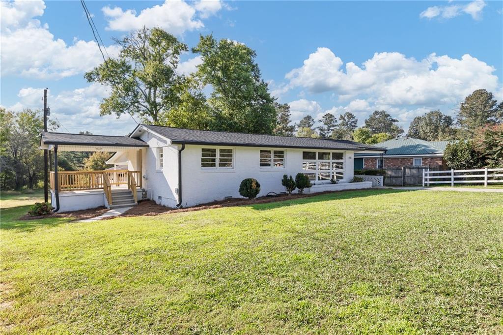 a view of a house with a swimming pool and a yard