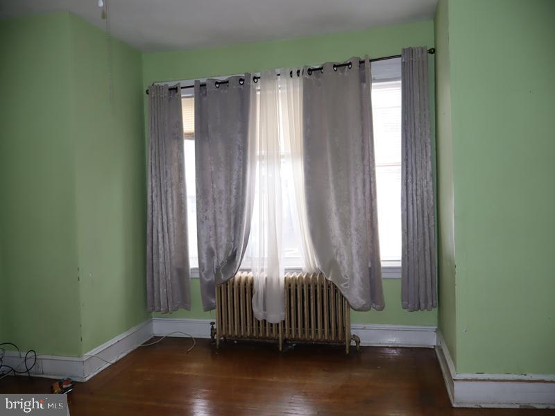 1502 68th Avenue Philadelphia, PA 19126 - Photo 11 of 20 a view of a bedroom with wooden floor and a window