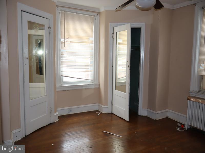 1502 68th Avenue Philadelphia, PA 19126 - Photo 13 of 20 an empty room with wooden floor closet and windows