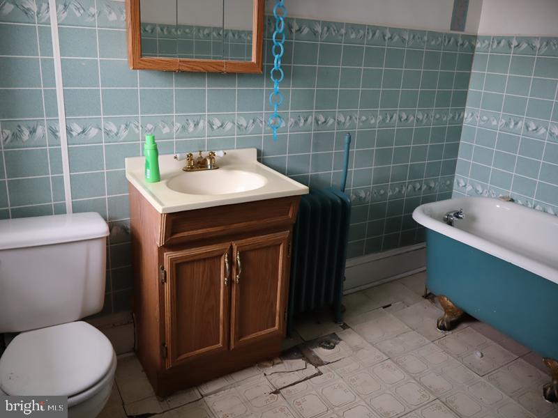 1502 68th Avenue Philadelphia, PA 19126 - Photo 17 of 20 a bathroom with a sink a toilet and a mirror