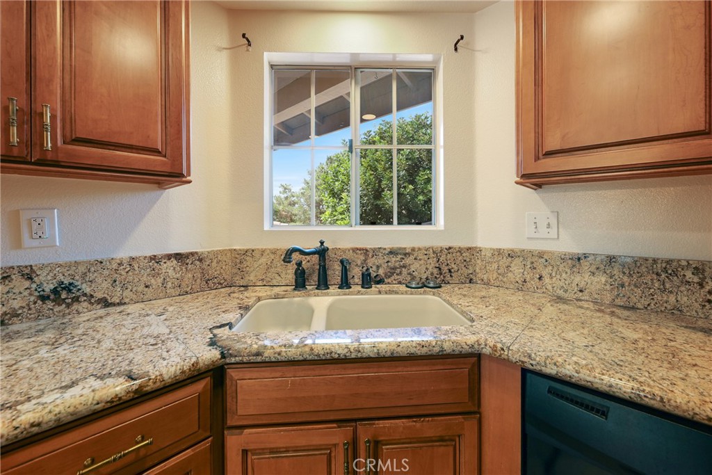 14 Abrigo Rancho Santa Margarita, CA 92688 - Photo 8 of 31 a kitchen with granite countertop sink and cabinets