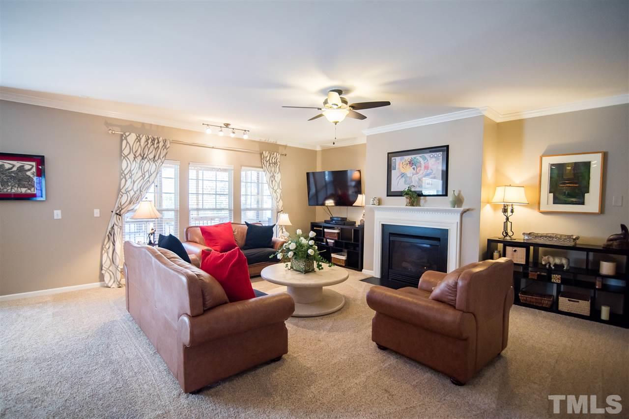 2307 Bright Future Way Raleigh, NC 27614 - Photo 5 of 23 The family room features fireplace, triple windows with backyard view and new Stain Master carpet.