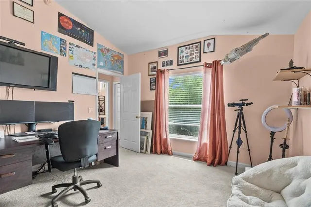 a workspace with furniture and a flat screen tv