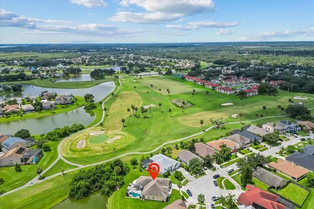 an aerial view of lake residential houses with outdoor space and swimming pool