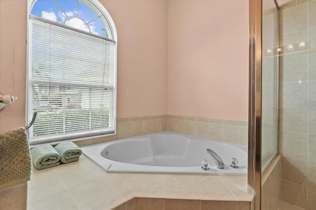 a bath tub sitting in a bathroom next to a window