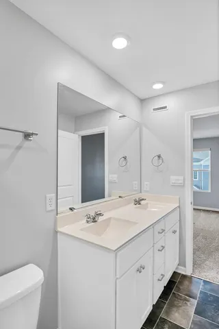 a bathroom with a double vanity sink and a mirror