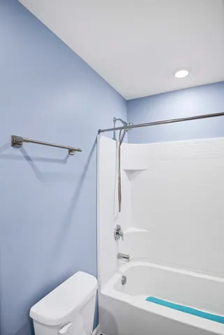 a bathroom with a toilet and a bathtub