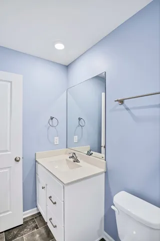 a bathroom with a sink a toilet and mirror