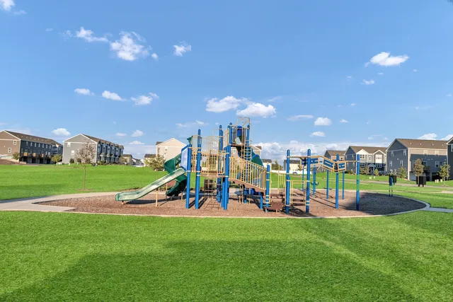 a view of a park with swings and slides