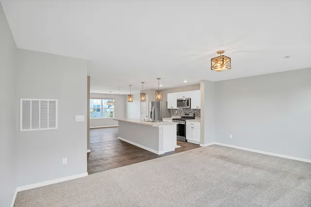 a view of a kitchen with kitchen island wooden floor and window