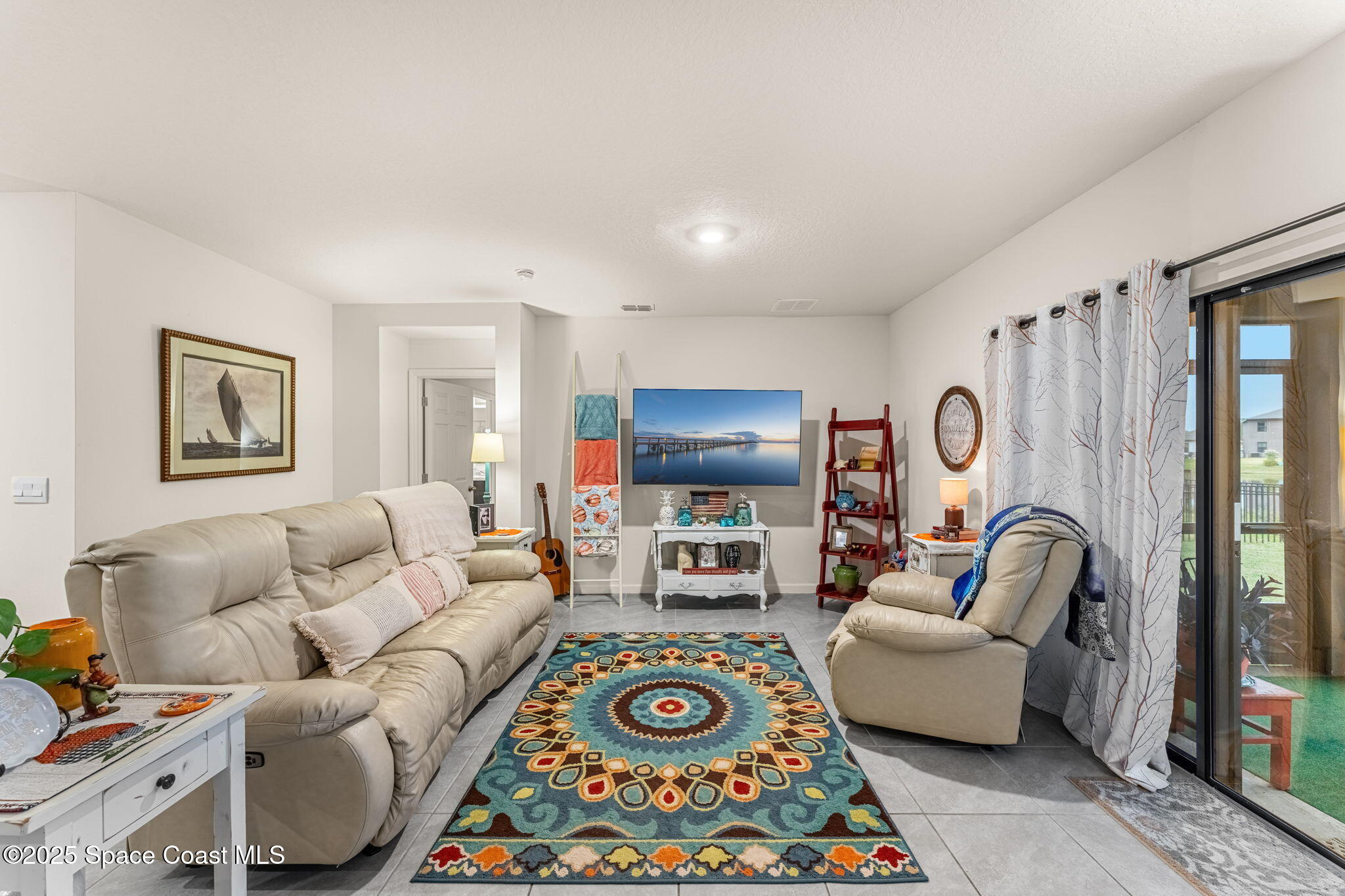 4901 Talbot Boulevard Cocoa, FL 32926 - Photo 18 of 39 a living room with furniture and a rug