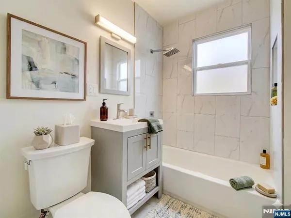 a bathroom with a sink a toilet and a bathtub