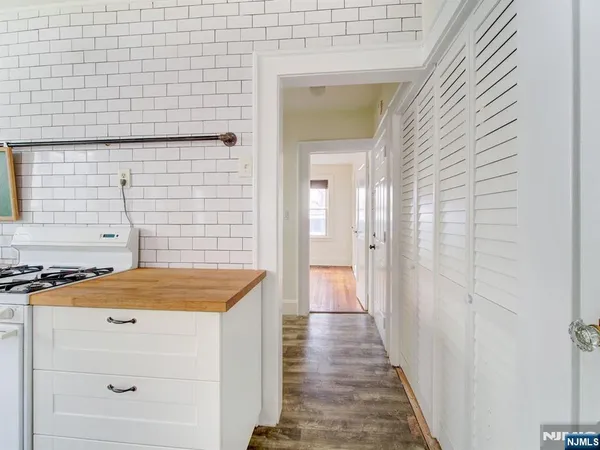 a bathroom with a granite countertop sink and a shower