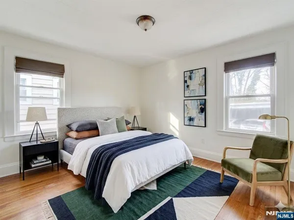 a bedroom with a bed a couch and a window