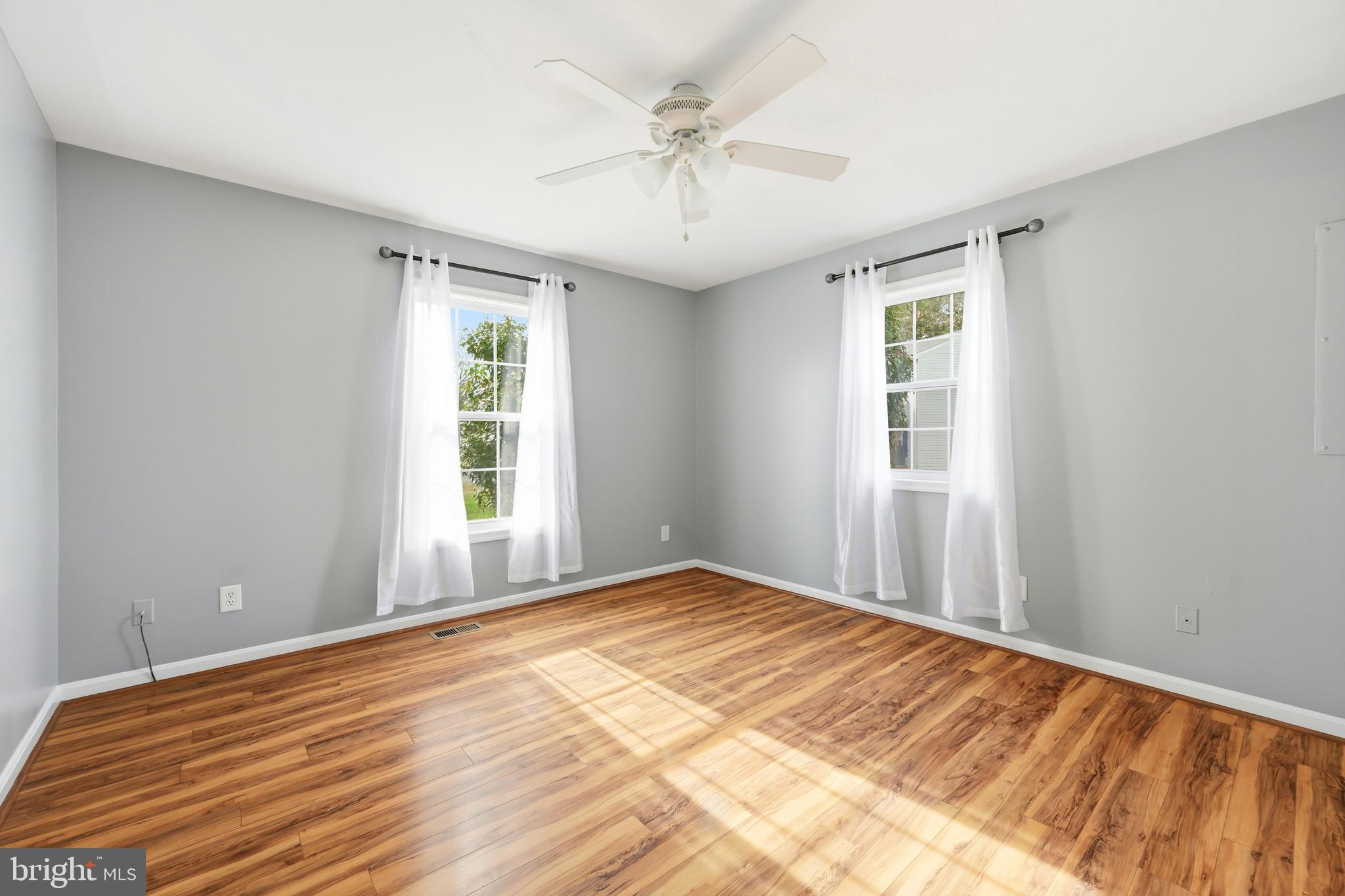 100 Bush Terrace St. Michaels, MD 21663 - Photo 22 of 40 a view of empty room with wooden floor and fan