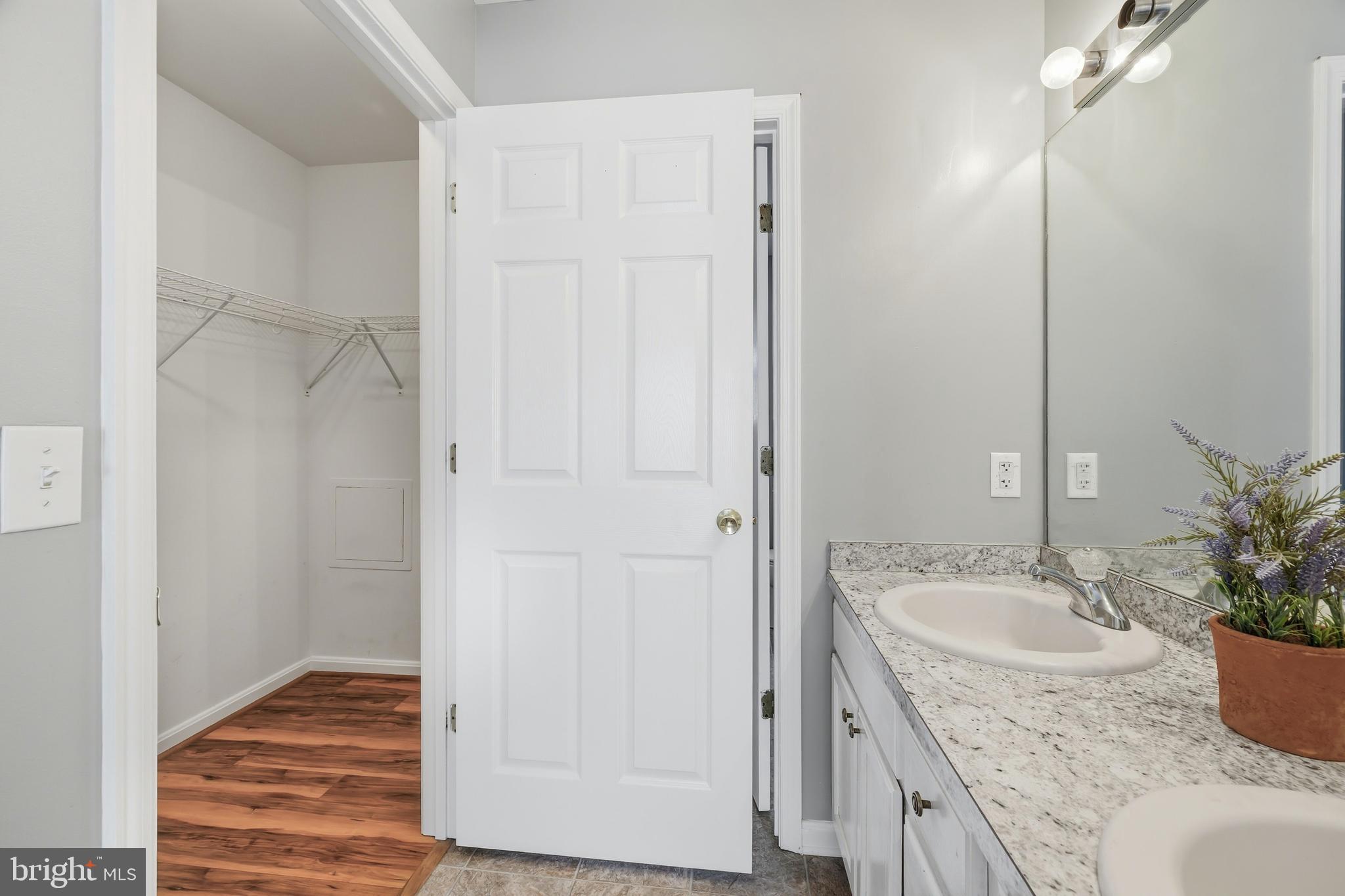 100 Bush Terrace St. Michaels, MD 21663 - Photo 25 of 40 a bathroom with a granite countertop sink and a mirror