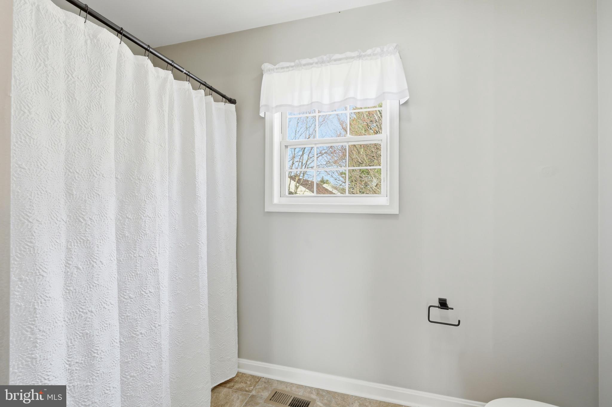 100 Bush Terrace St. Michaels, MD 21663 - Photo 26 of 40 a bathroom with a window and a shower curtain