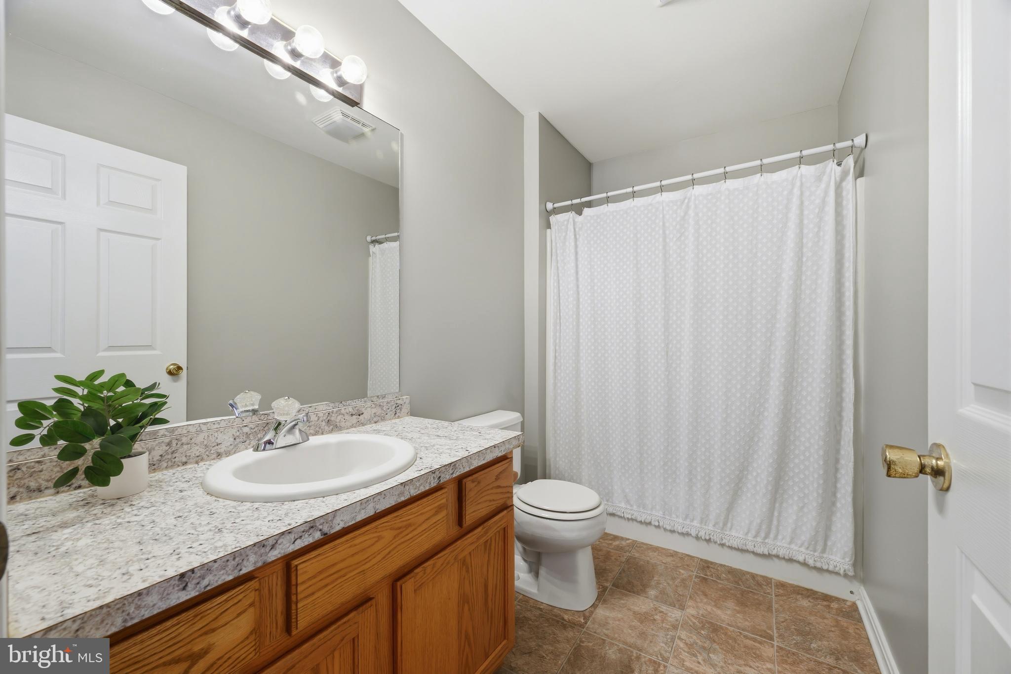 100 Bush Terrace St. Michaels, MD 21663 - Photo 33 of 40 a bathroom with a granite countertop sink toilet and shower