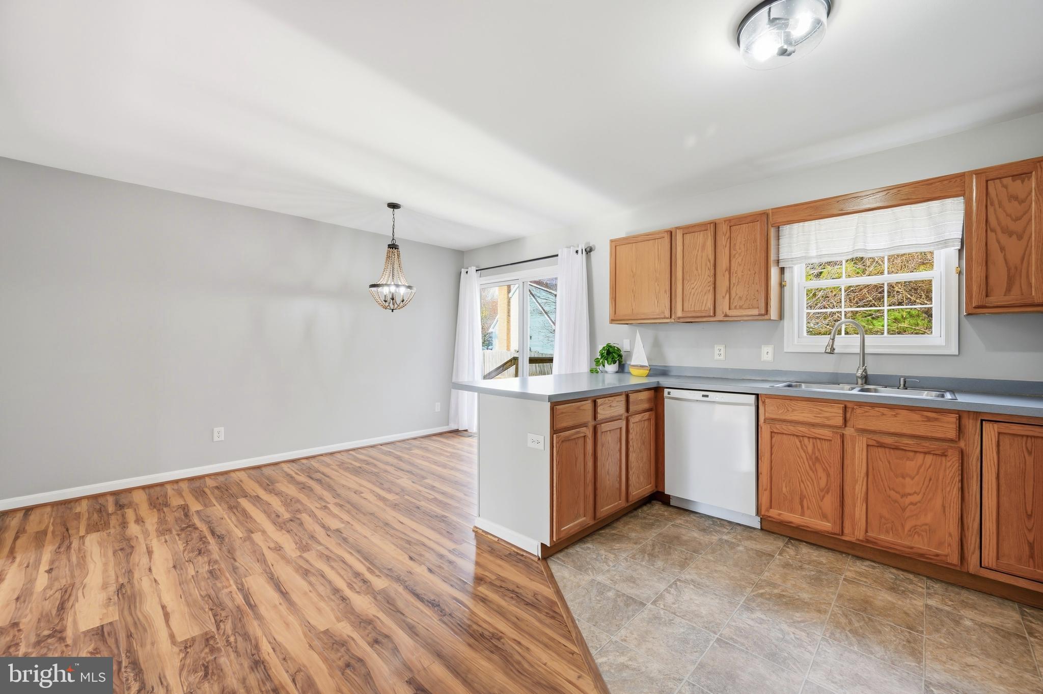 100 Bush Terrace St. Michaels, MD 21663 - Photo 9 of 40 a kitchen with stainless steel appliances granite countertop a sink cabinets and wooden floor