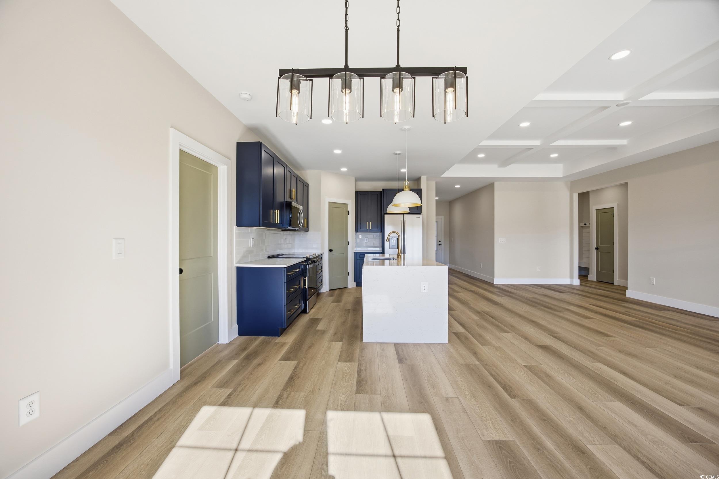 631 Highway 548 Conway Sc 29527 Conway, SC 29527 - Photo 39 of 40 Kitchen featuring decorative light fixtures, decorative backsplash, open floor plan, a center island with sink, and coffered ceiling