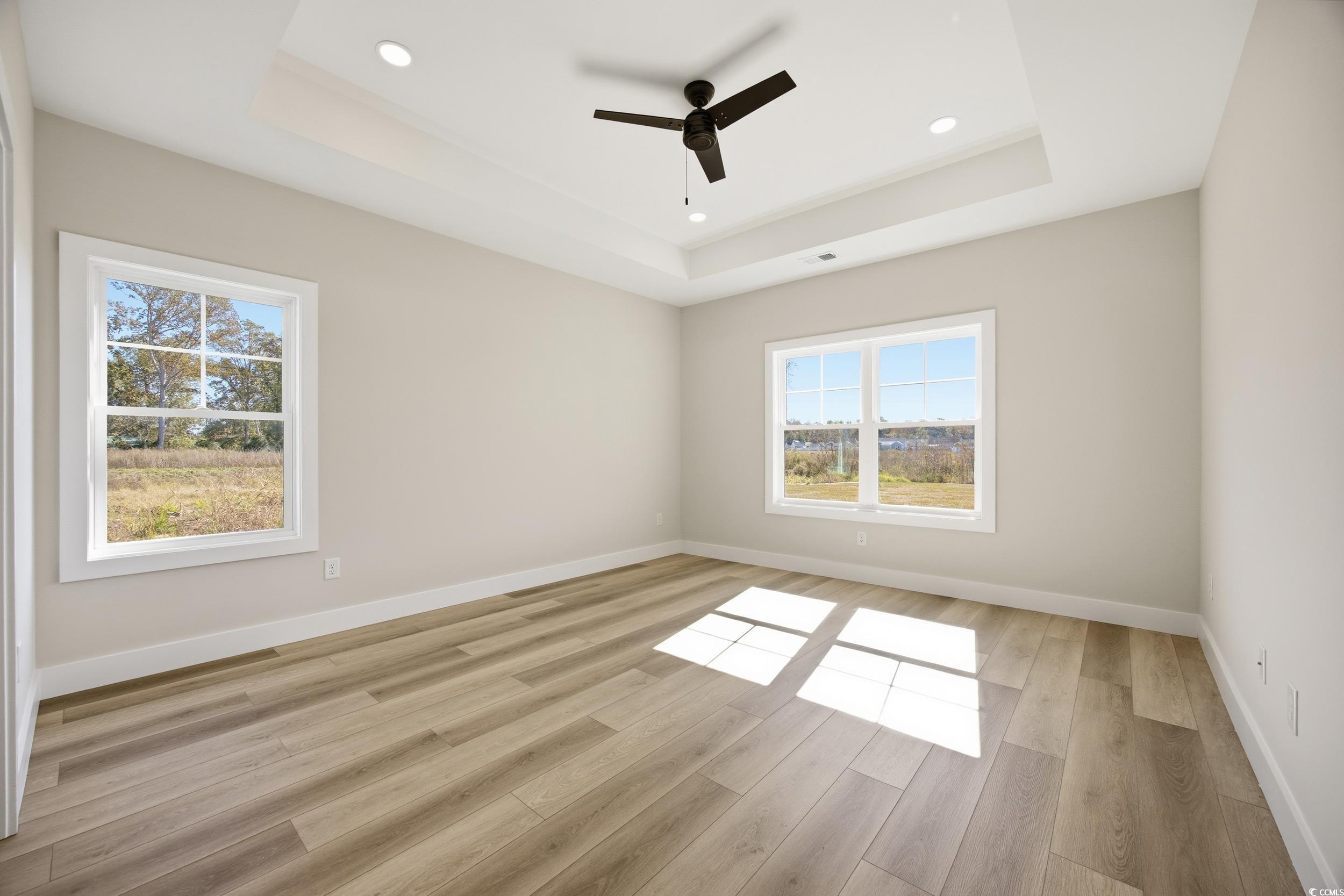 631 Highway 548 Conway Sc 29527 Conway, SC 29527 - Photo 15 of 40 Empty room featuring a raised ceiling, light wood-style flooring, recessed lighting, and ceiling fan