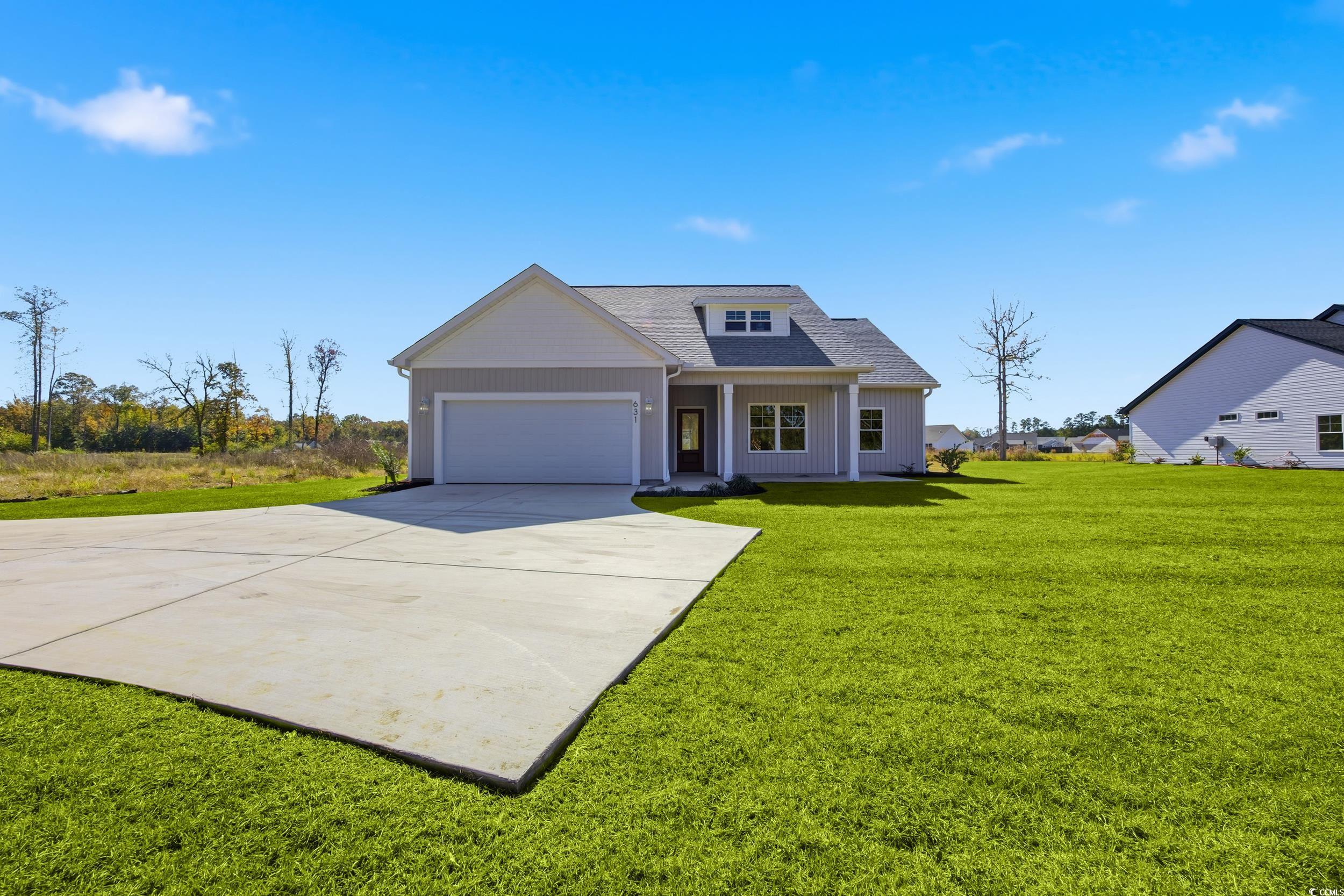 631 Highway 548 Conway Sc 29527 Conway, SC 29527 - Photo 2 of 40 View of front of home with a front lawn, driveway, roof with shingles, covered porch, and a garage