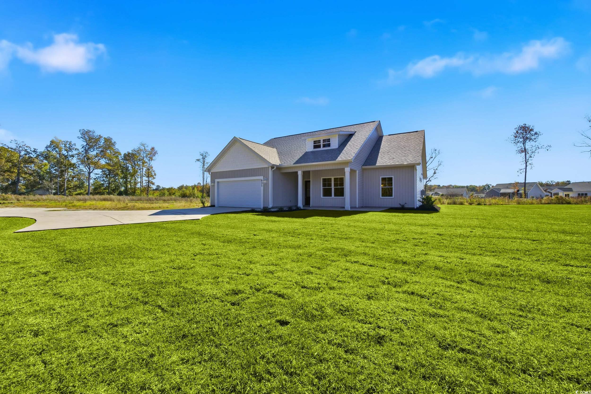 631 Highway 548 Conway Sc 29527 Conway, SC 29527 - Photo 3 of 40 View of front of home with a front lawn, concrete driveway, covered porch, and an attached garage