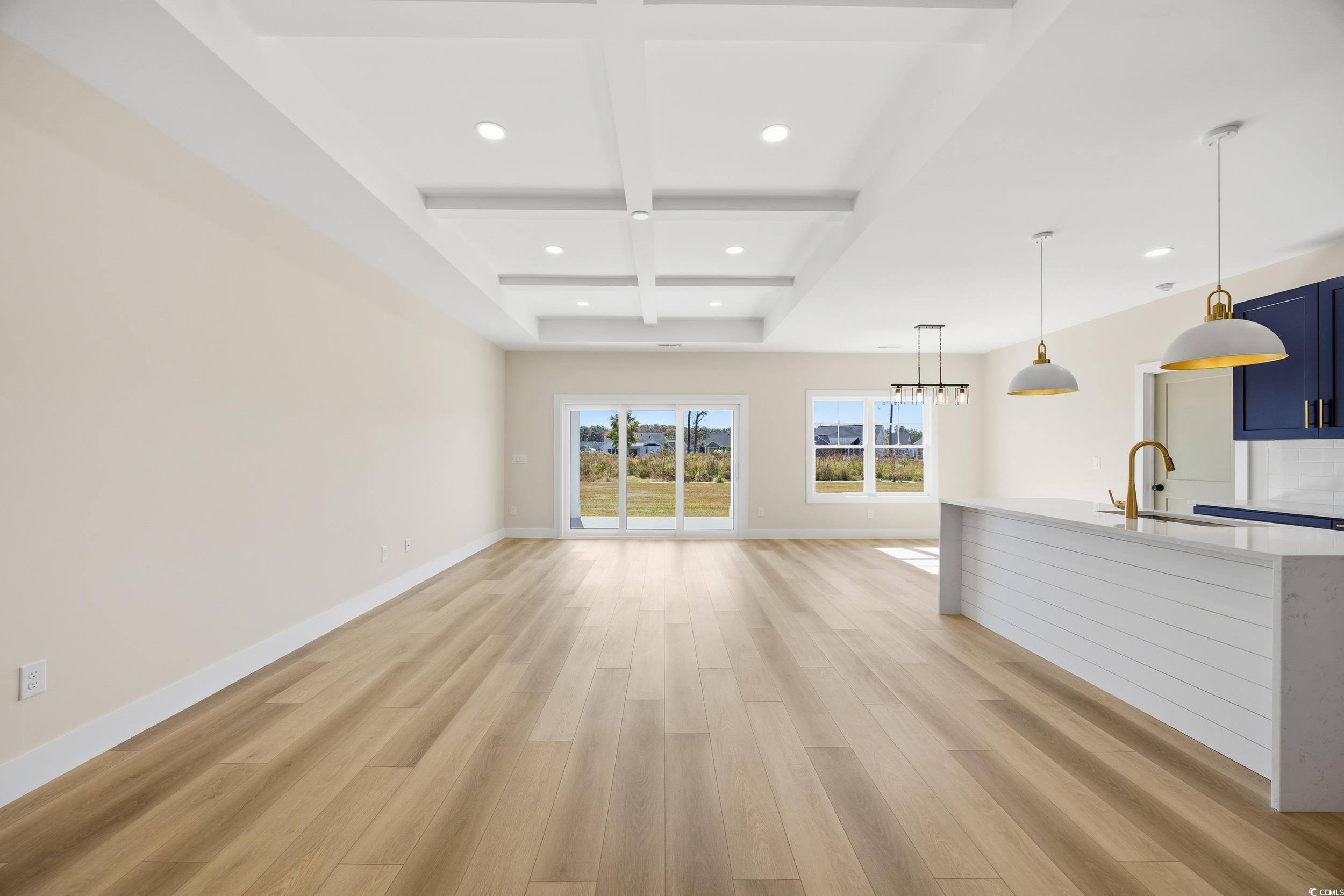 631 Highway 548 Conway Sc 29527 Conway, SC 29527 - Photo 6 of 40 Unfurnished living room with beamed ceiling, light wood-type flooring, coffered ceiling, and recessed lighting