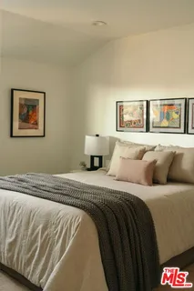 a bedroom with a bed and wall painting
