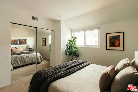 a bedroom with a large bed and a couch