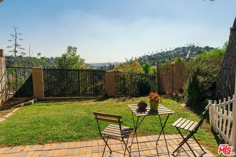 a view of a chairs and table in patio