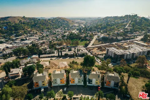 an aerial view of residential building and car parked