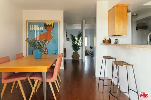 a view of a dining room with furniture and a chandelier