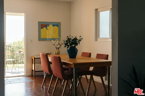 a dining room with furniture and wooden floor