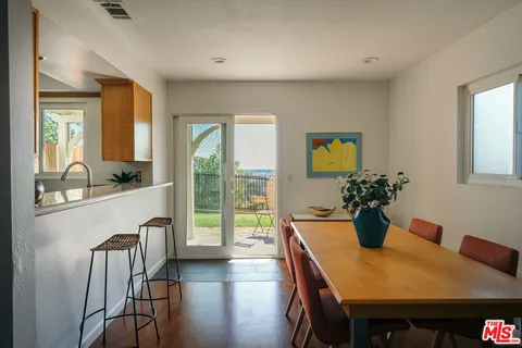 a view of a dining room with furniture window and wooden floor