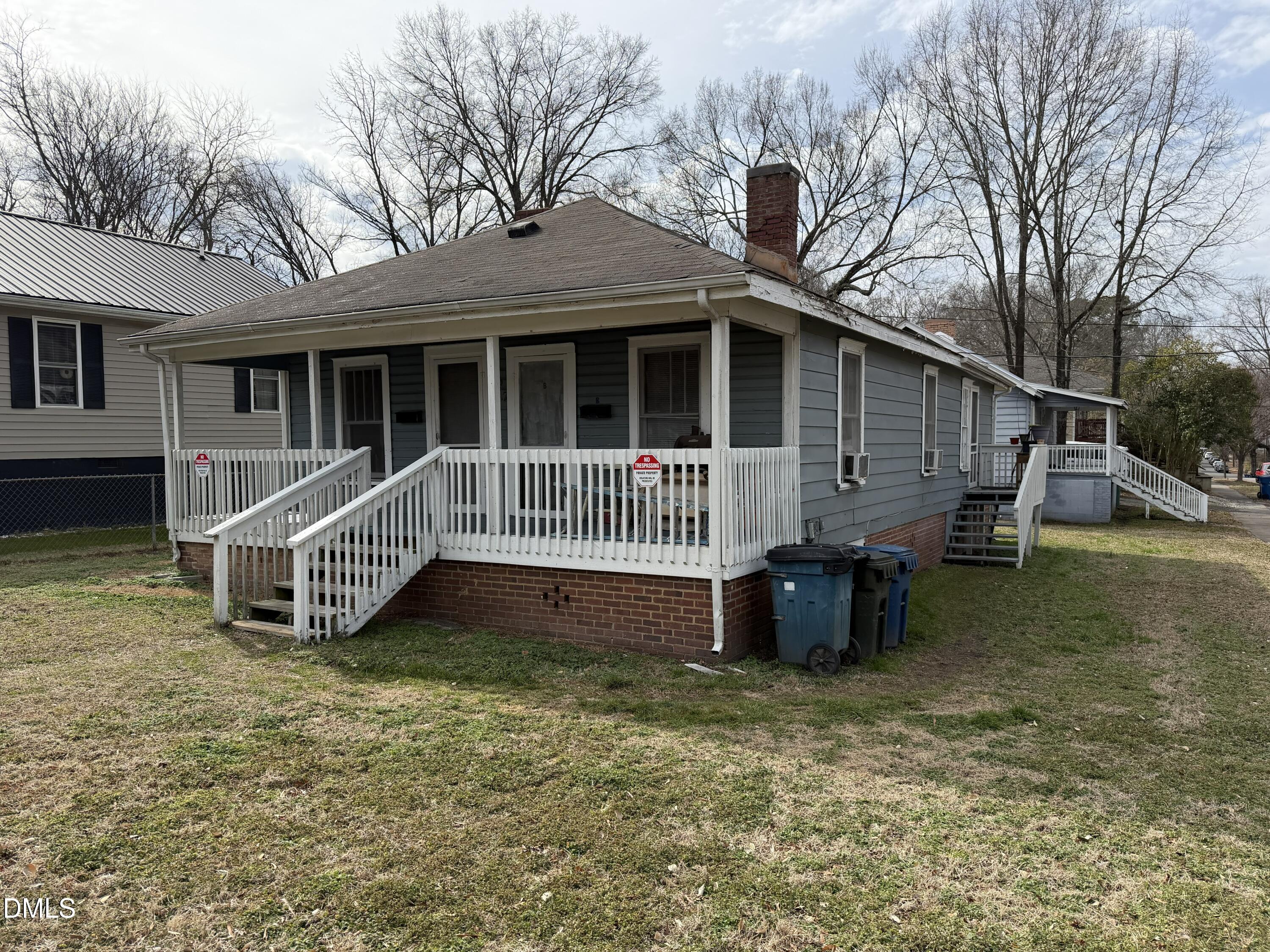 a view of a house with a yard and deck