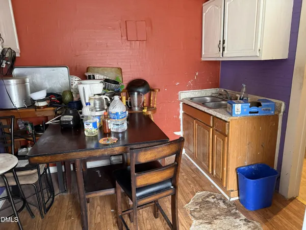 a kitchen with a stove and a dining table with kitchen island
