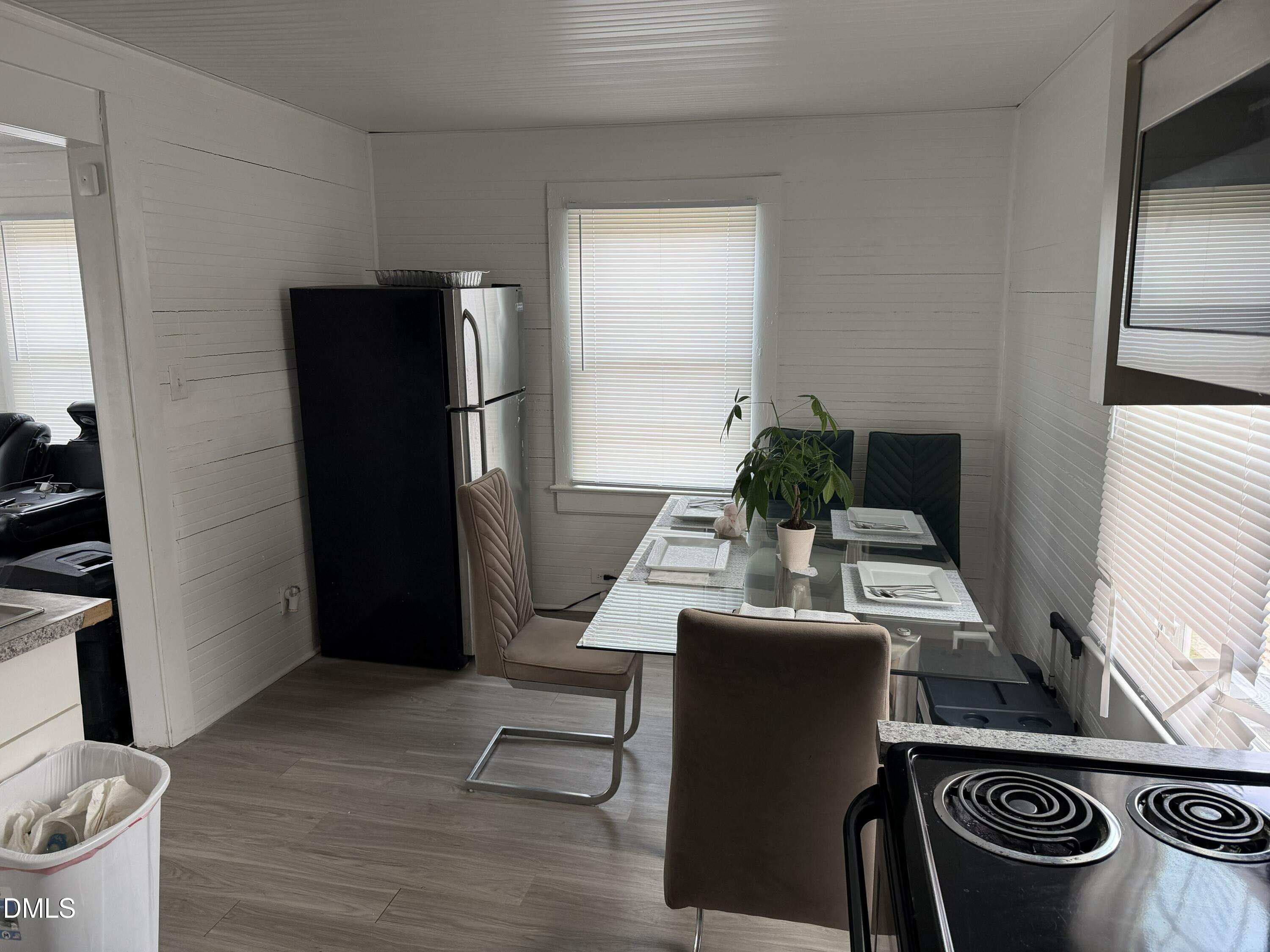 927 Berkeley Street Durham, NC 27705 - Photo 7 of 13 a living room with furniture mirror and a potted plant
