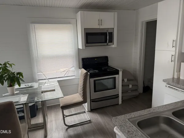 a kitchen with a stove a microwave and a counter top space