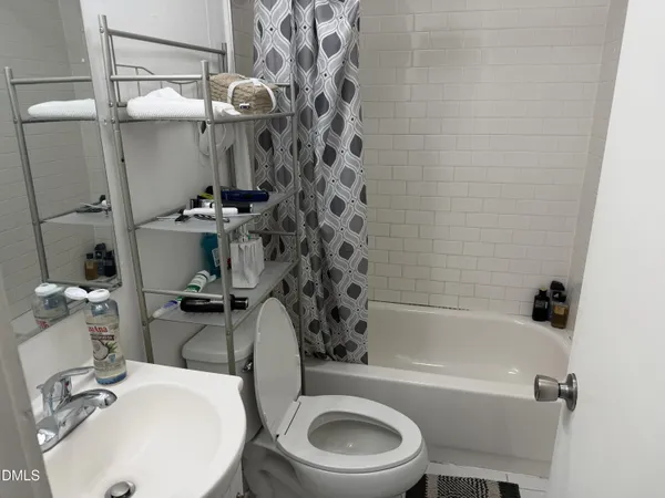 a bathroom with a sink a toilet and bathtub