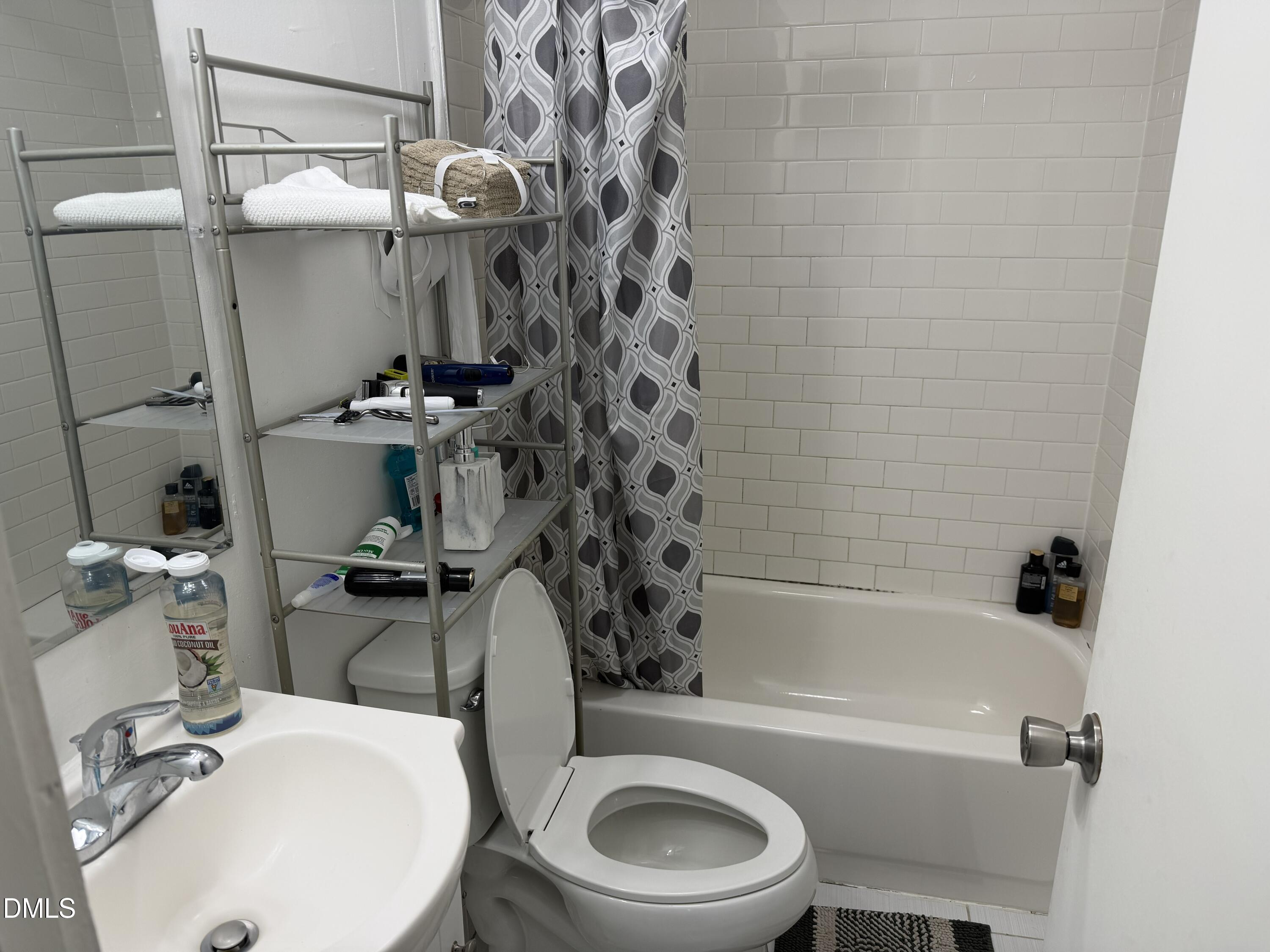 927 Berkeley Street Durham, NC 27705 - Photo 10 of 13 a bathroom with a sink a toilet and bathtub