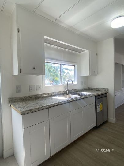 821 West Bennett Street Ridgecrest, CA 93555 - Photo 9 of 26 a kitchen with granite countertop white cabinets and a sink