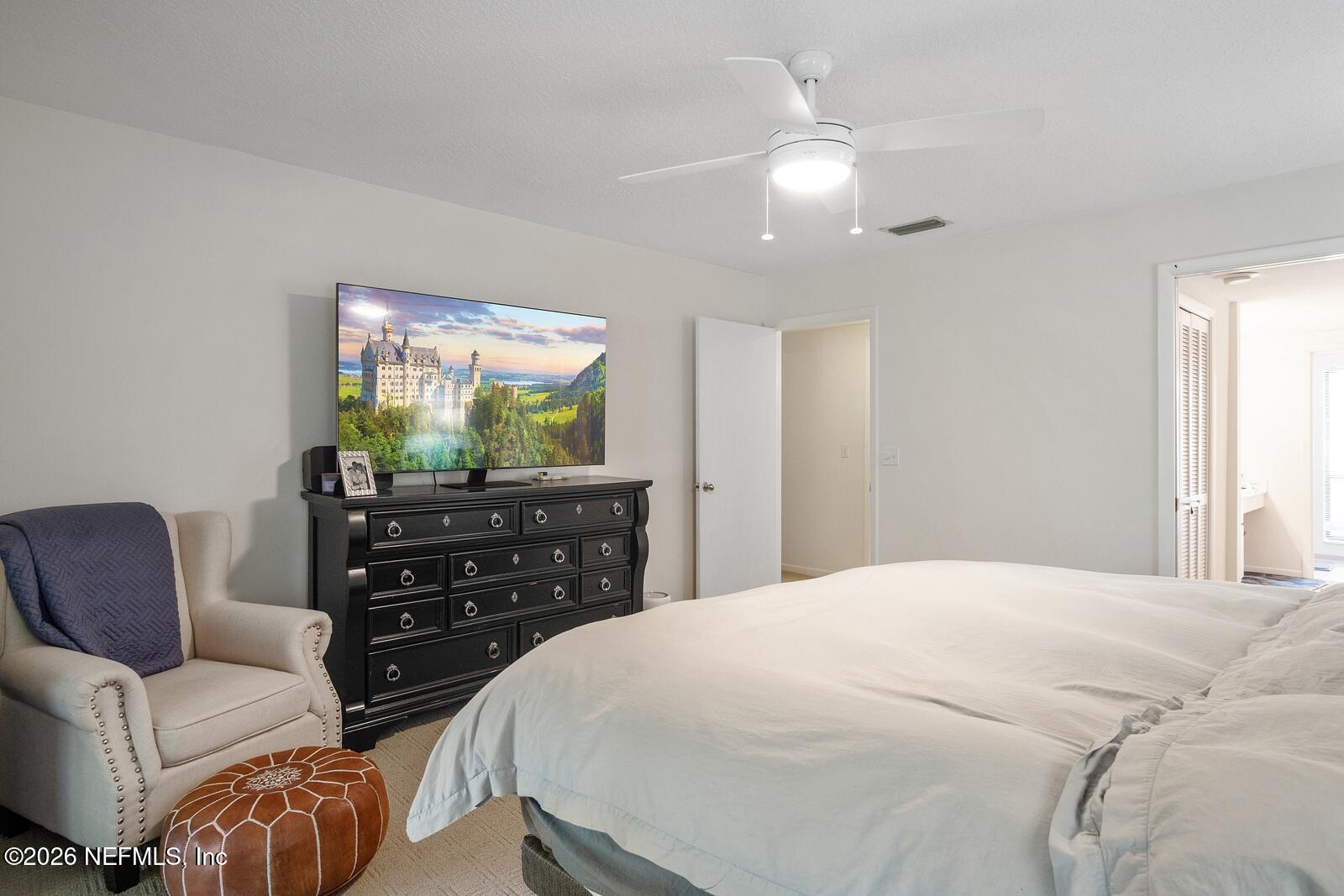 8012 Hollyridge Road, Unit 17U Jacksonville, FL 32256 - Photo 12 of 22 a bedroom with a bed and a dresser