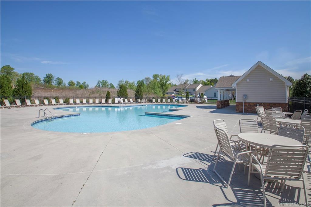 228 Falling Ridge, Unit 151 Belmont, NC 28012 - Photo 15 of 15 a view of a swimming pool and lounge chairs
